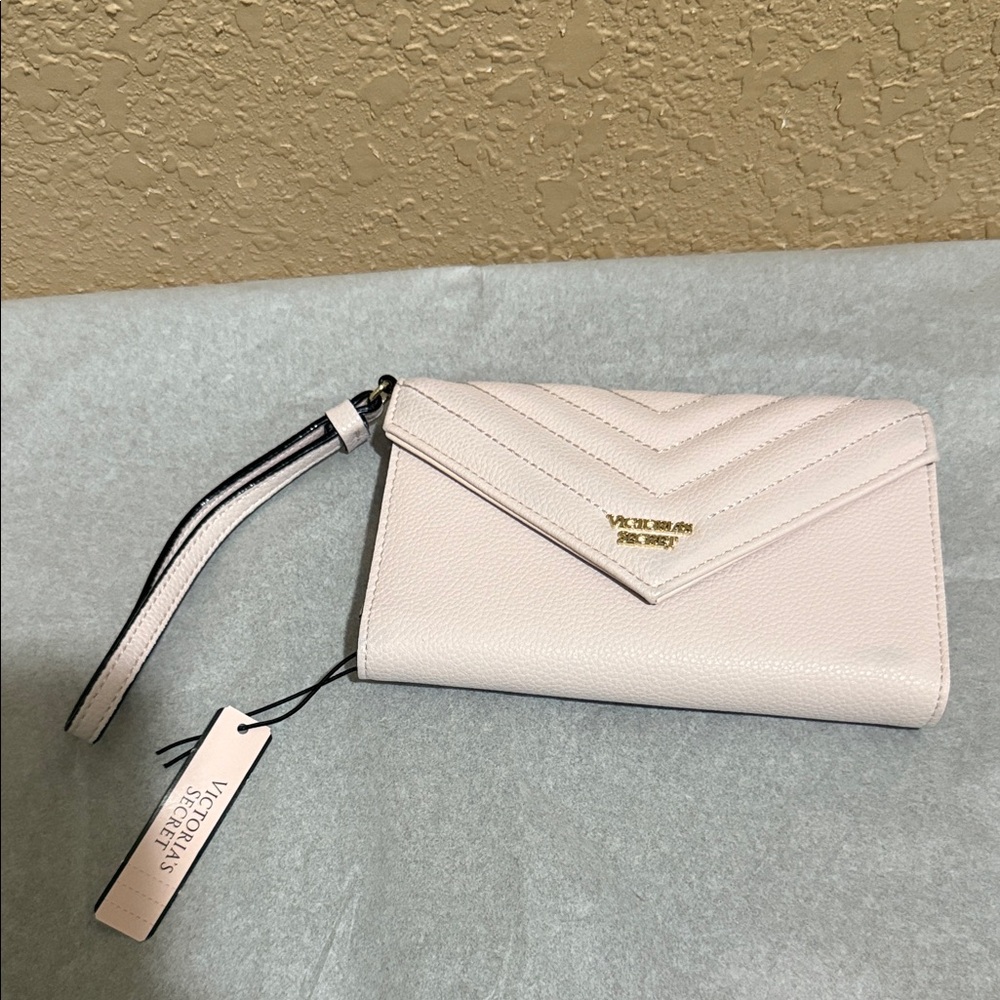 NWT Victoria's Secret Light Pink Wristlet Clutch. Small blemishes on front.